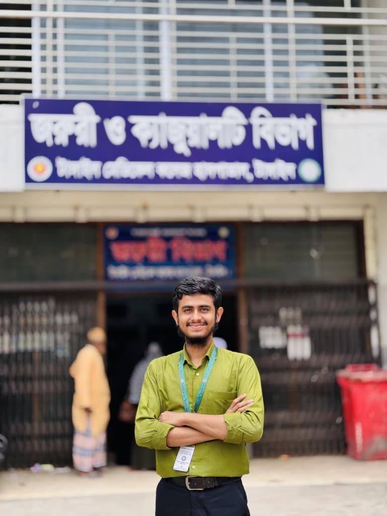 Tanvir Ahmad, Intern Nurse, standing outside the Emergency and Casualty Department at Tangail Medical College Hospital
