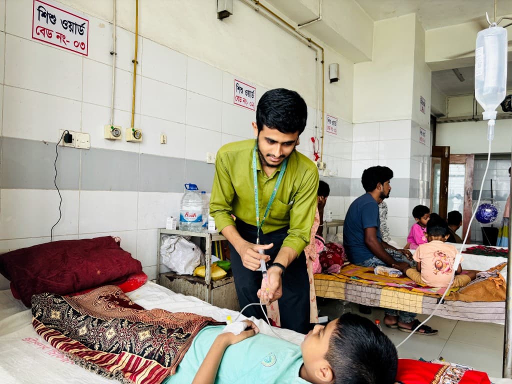 Tanvir Ahmad giving an injection to a pediatric patient in the pediatrics ward